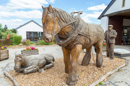 Horse and farmer statue carved on woodの写真素材