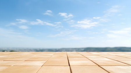 Wooden table top on blurred background of blue sky with clouds.の素材