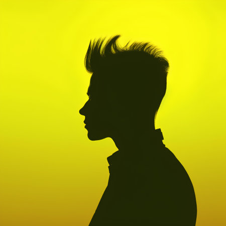 Silhouette of a man's head on a yellow background.の素材
