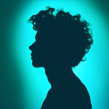 Silhouette of a woman with curly hair on a green backgroundの素材