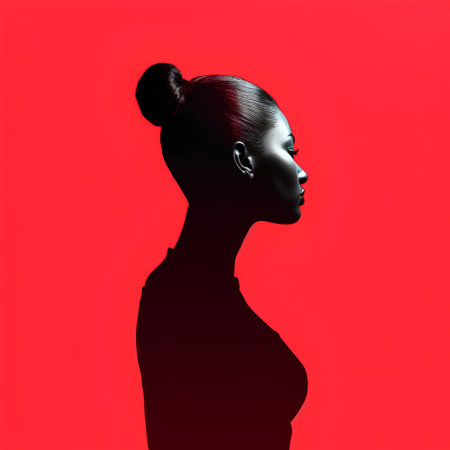 Silhouette of a beautiful African American woman on a red background.の素材