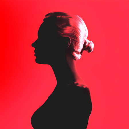 Silhouette of a beautiful woman in profile on a red backgroundの素材