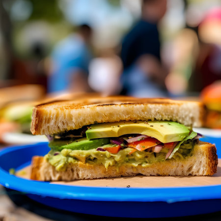 Sandwich with avocado, tomato and cucumber on a plate.の素材