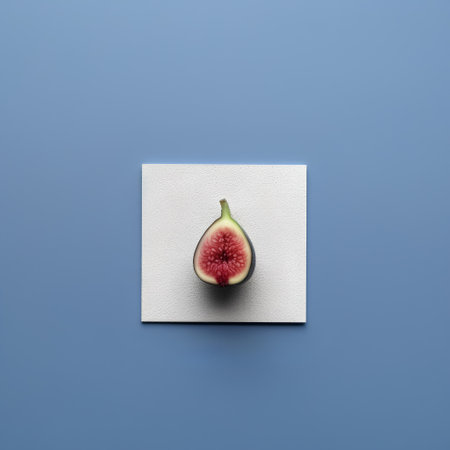 Creative layout made of fresh figs on blue background. Flat lay, top view minimal food concept.の素材