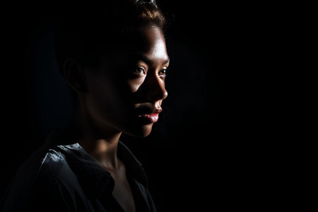 Portrait of a young african american woman on black backgroundの素材