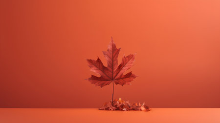 Autumn maple leaf on orange background. Minimal concept. 3D Renderingの素材