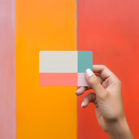 Hand holding blank business card on colorful background, mockup for designの素材