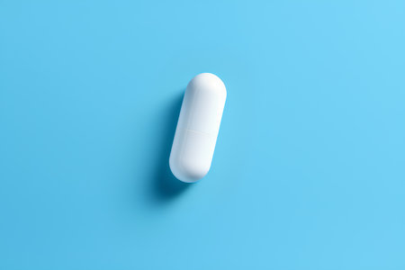 White pill on blue background. Minimal style. 3d illustrationの素材