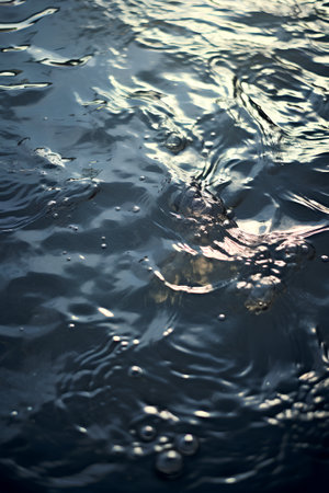 raindrops on the surface of the water in the rays of the sunの素材