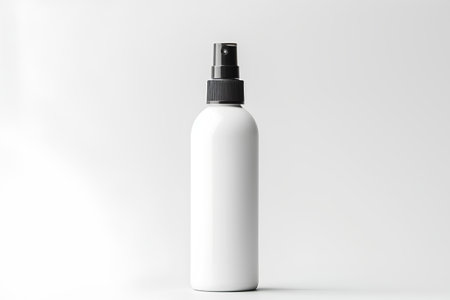 Blank white cosmetic bottle with black cap on white background. 3d renderingの素材