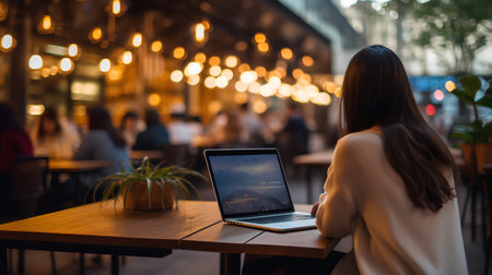 Young woman using a laptop in a coffee shop. Business and technology concept.の素材