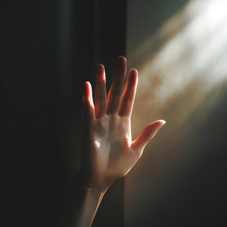 Close up of woman's hand with light coming through the window.の素材