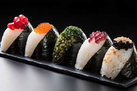Sushi set on a black background. Sushi rolls with salmon, tuna, eel, caviar, avocado, nori, red caviar.の素材