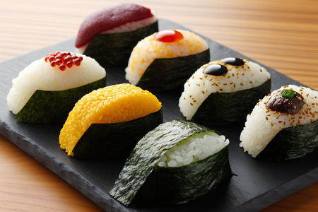 sushi on a black stone plate on a wooden table, verticalの素材