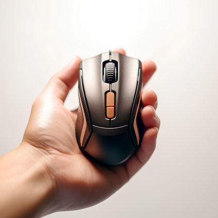 male hand holding a wireless computer mouse on a light background, close-upの素材