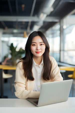 portrait of young asian businesswoman using laptop computer in officeの素材