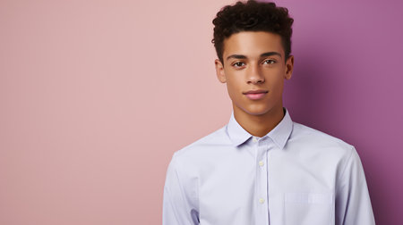 Young african american man in white shirt posing on pink backgroundの素材