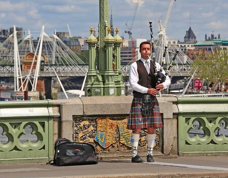 London, Great Britain -May 22, 2016: Scottish piper on the Westminster Bridge in Londonのeditorial素材