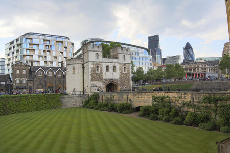 London, Great Britain -May 23, 2016: The old fortress Tower on the banks of the River Thames on a spring day against the background of modern buildingsのeditorial素材