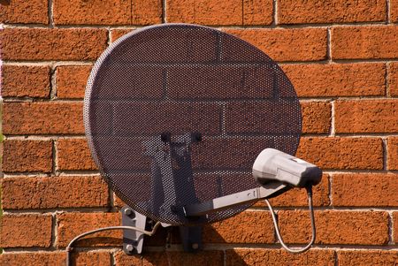satellite antenna on  wall of one of  houses in  vicinity of Liverpool / United Kingdom, 16.05.2009 の写真素材