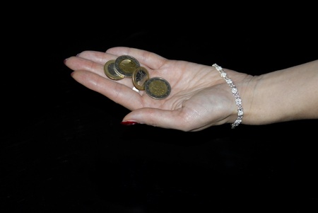 Young female hand full of euro coins