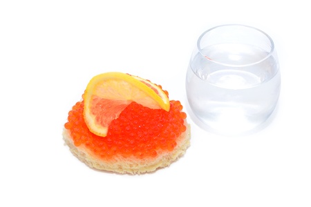 Bread with red caviar and glass of vodka isolated on white