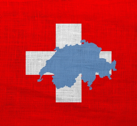 Flag and map of Switzerland on a sackclothの写真素材