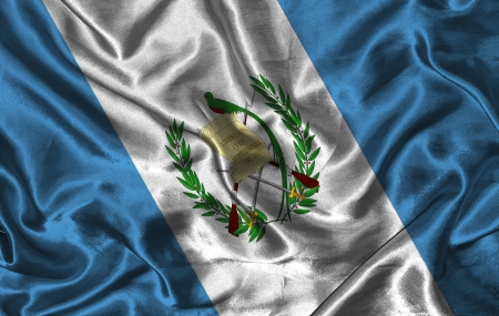 Waving colorful Guatemala flag on a silk backgroundの写真素材