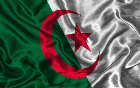 Waving colorful Algeria flag on a silk backgroundの写真素材