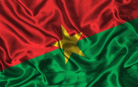 Waving colorful Burkina Faso flag on a silk backgroundの写真素材