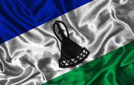 Waving colorful Lesotho flag on a silk backgroundの写真素材