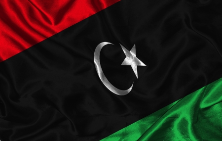 Waving colorful Libya flag on a silk backgroundの写真素材