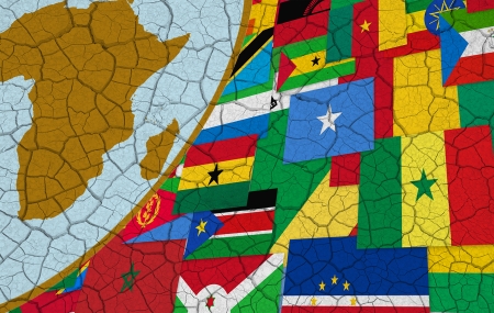 Map of Africa and African flags on dry cracked background