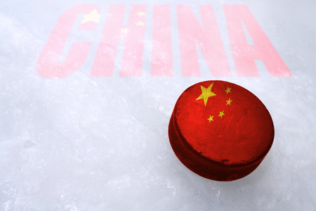 Vintage old hockey puck with the China flag is on the iceの写真素材
