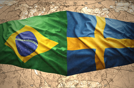 Waving Swedish and Brazilian flags of the political map of the worldの写真素材