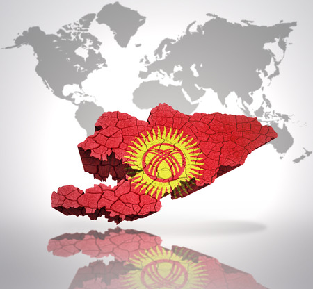 Map of Kyrgyzstan with Kyrgyz Flag on a world map backgroundの写真素材