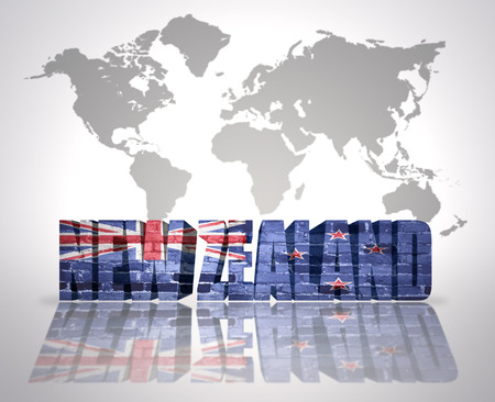 Word New Zealand with New Zealand Flag on a world map backgroundの写真素材