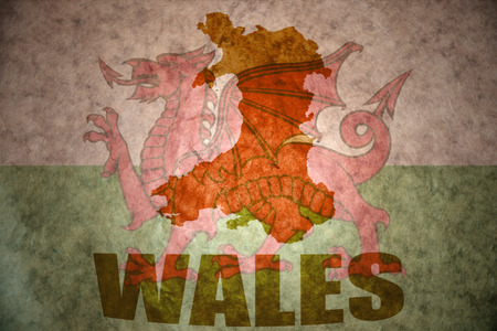 wales map on a vintage welsh flag backgroundの写真素材