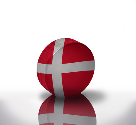 vintage old hockey puck with the danish flagの写真素材