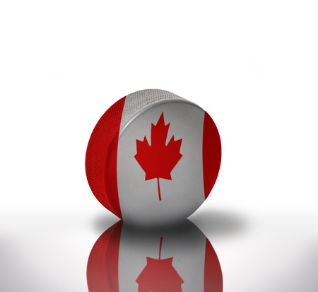vintage old hockey puck with the canadian flagの写真素材