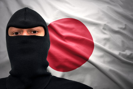 dangerous man in a mask on a japanese flag background