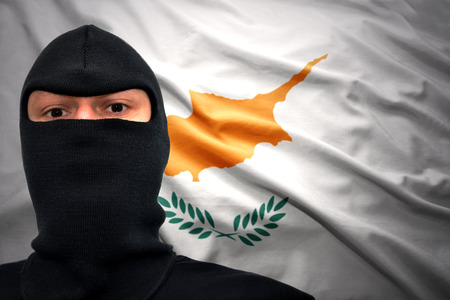 dangerous man in a mask on a cypriot flag backgroundの写真素材