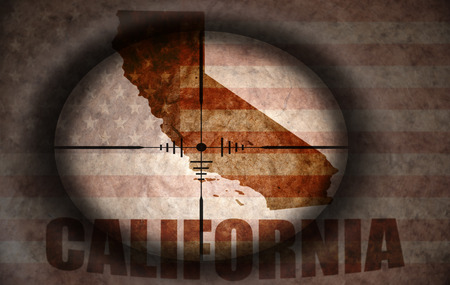 sniper scope aimed at the vintage american flag and california state mapの写真素材