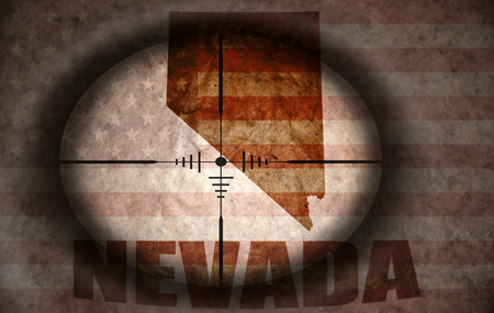 sniper scope aimed at the vintage american flag and nevada state mapの写真素材