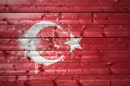 colorful painted turkish flag on a wooden textureの写真素材