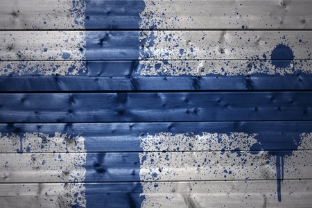 colorful painted finnish flag on a wooden textureの写真素材