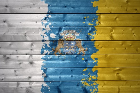 colorful painted canarian flag on a wooden textureの写真素材