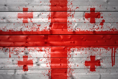colorful painted georgian flag on a wooden textureの写真素材