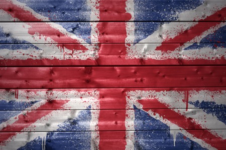 colorful painted british flag on a wooden textureの写真素材