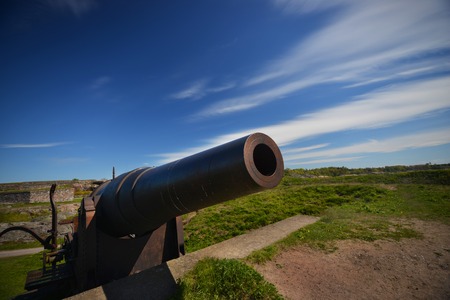 Old weapon under blue dramatic skiesの写真素材